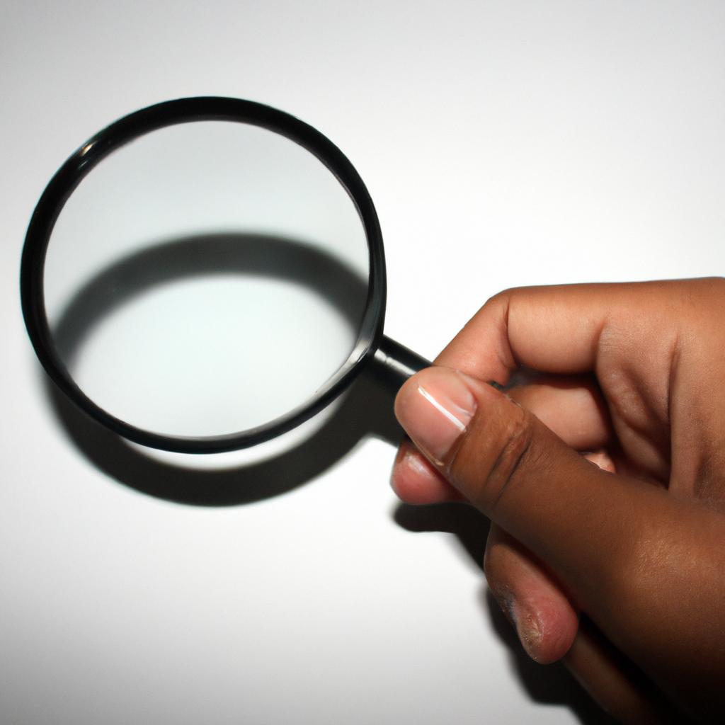 Person holding a magnifying glass